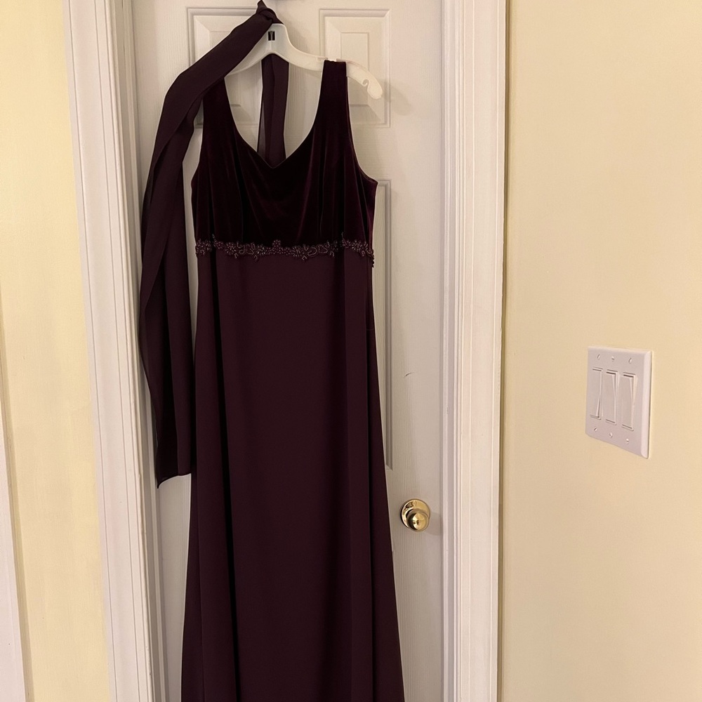 Long dress. Sleeveless. Not really purple more wine/burgundy.